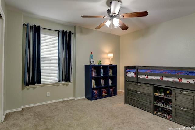 bedroom featuring ceiling fan and light carpet