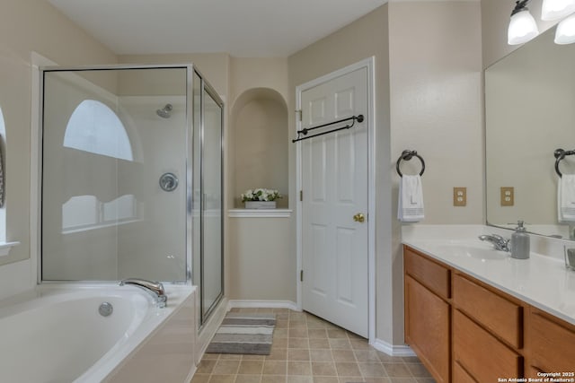 bathroom with vanity, tile patterned floors, and plus walk in shower