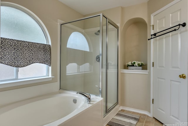 bathroom featuring shower with separate bathtub