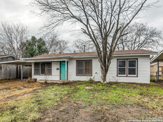 single story home featuring a front yard and a carport