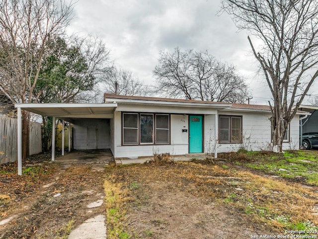 ranch-style house featuring a carport