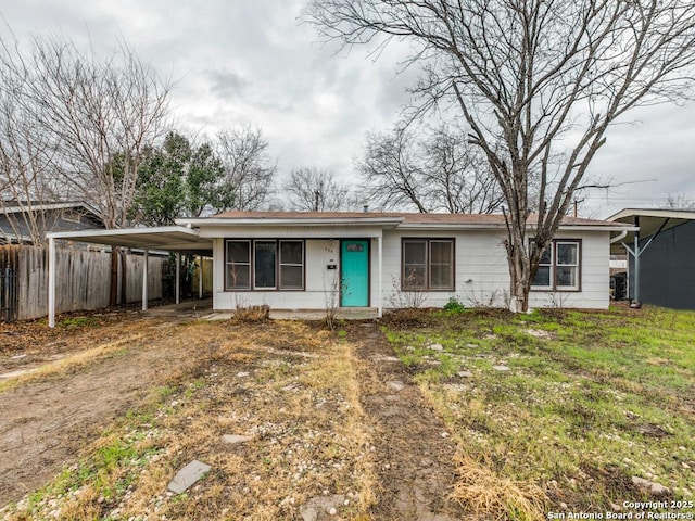 single story home with a carport and a front yard