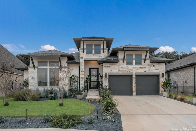 prairie-style home with a garage and a front lawn