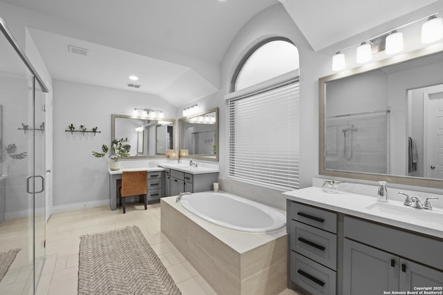 bathroom with lofted ceiling, vanity, tile patterned floors, and separate shower and tub