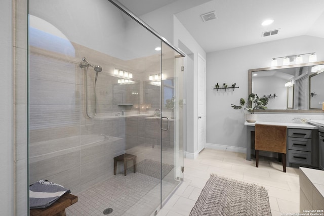 bathroom featuring an enclosed shower, vanity, tile patterned flooring, and vaulted ceiling