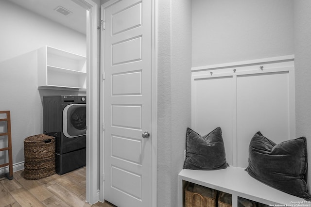 laundry area with washer / clothes dryer and light hardwood / wood-style floors