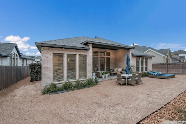 back of property with a patio