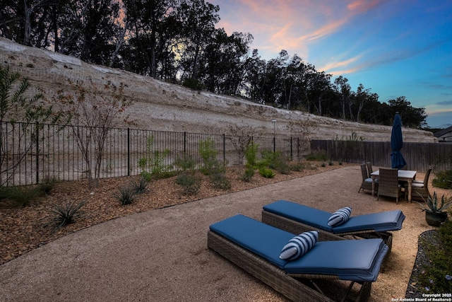 view of patio terrace at dusk