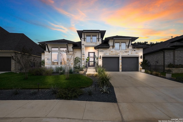 view of front of property featuring a garage and a yard