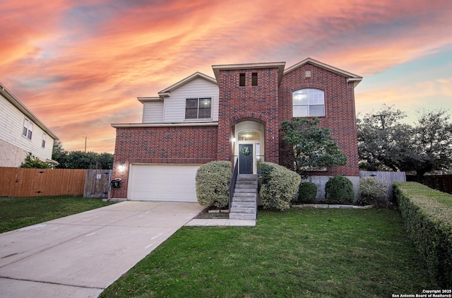 traditional home featuring driveway, an attached garage, a front yard, and brick siding