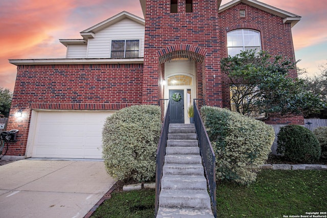 traditional-style house featuring concrete driveway and brick siding