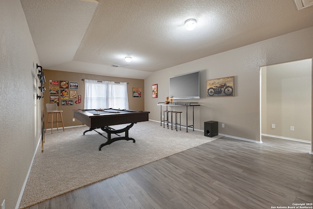 playroom featuring baseboards, a textured wall, wood finished floors, pool table, and a textured ceiling