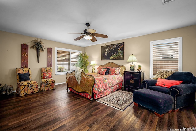 bedroom with dark hardwood / wood-style floors and ceiling fan