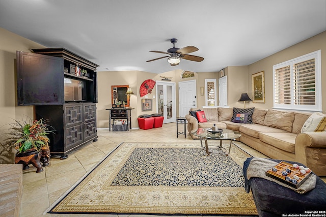 living room with light tile patterned flooring, plenty of natural light, and ceiling fan