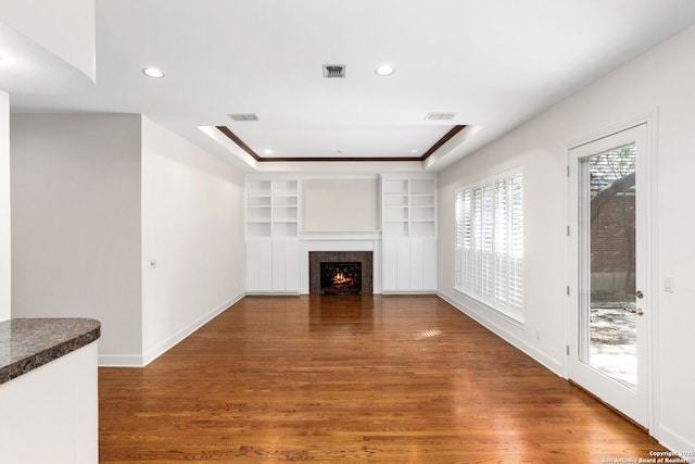 unfurnished living room with recessed lighting, visible vents, and wood finished floors