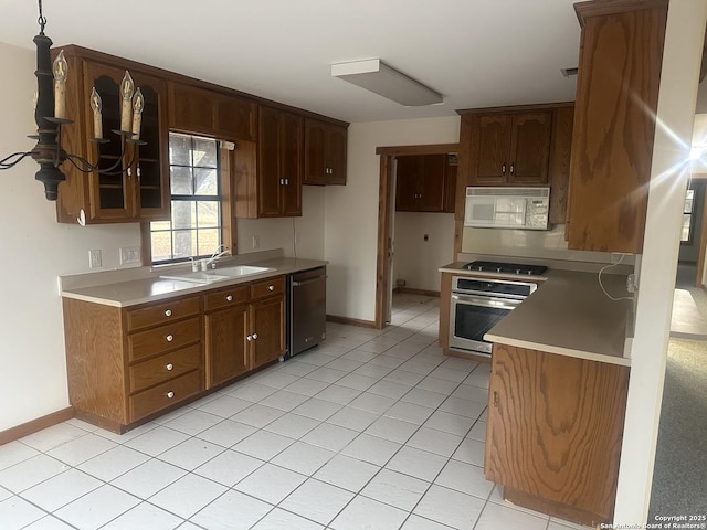 kitchen featuring sink, light tile patterned flooring, and appliances with stainless steel finishes