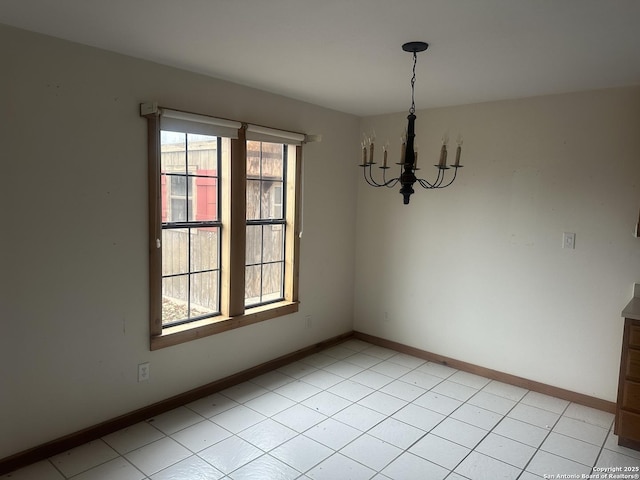 unfurnished dining area featuring a chandelier