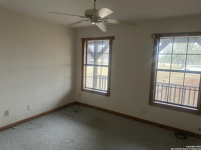 empty room featuring carpet floors and ceiling fan