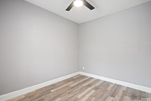 unfurnished room with light wood finished floors, baseboards, and a ceiling fan