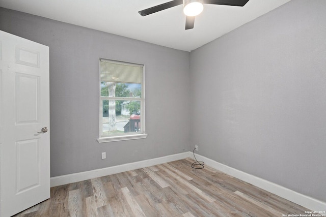 unfurnished room with baseboards, a ceiling fan, and wood finished floors