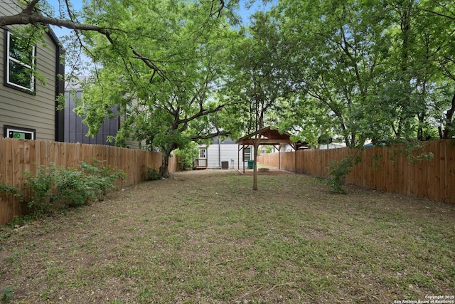view of yard with a fenced backyard and a gazebo