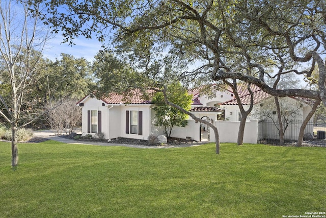 mediterranean / spanish house with central AC and a front yard