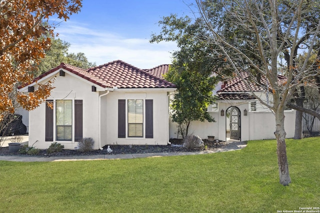 mediterranean / spanish house with a front yard