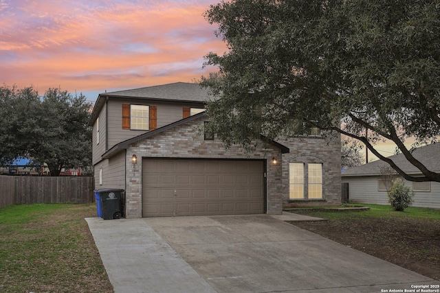 view of front of house featuring a garage and a lawn