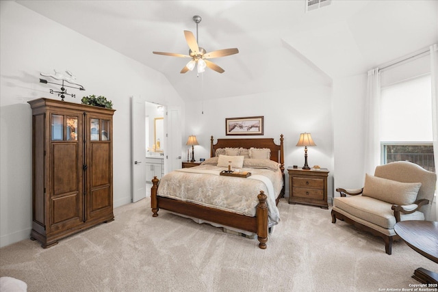 bedroom with lofted ceiling, ensuite bath, light carpet, and ceiling fan