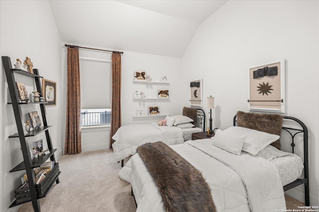 bedroom featuring vaulted ceiling and light carpet