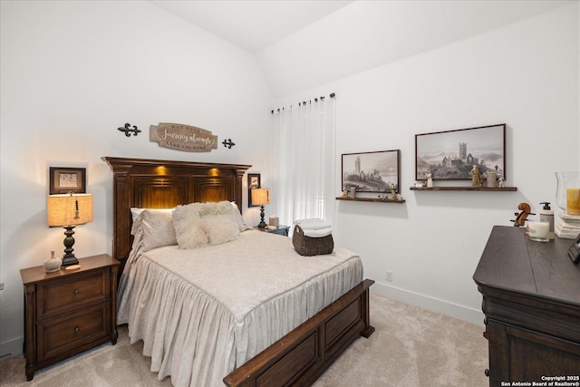 bedroom featuring lofted ceiling and light colored carpet