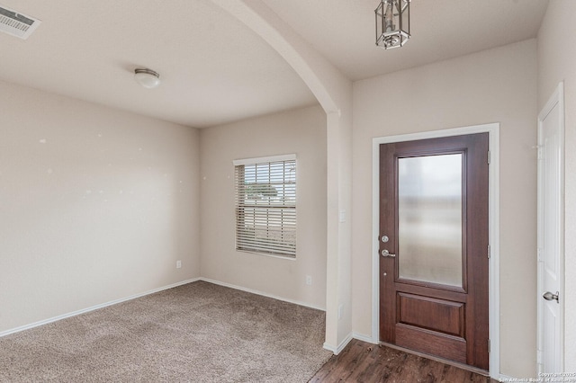 entryway featuring dark carpet