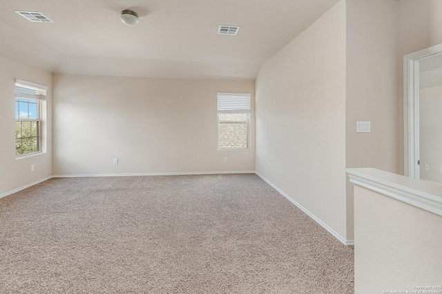 unfurnished room featuring light carpet