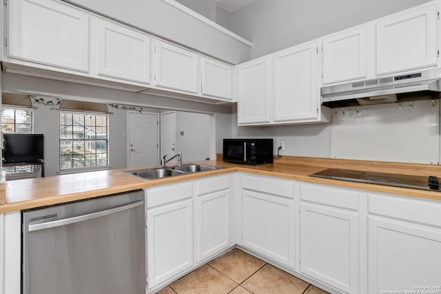 kitchen with light tile patterned flooring, white cabinets, sink, and black appliances