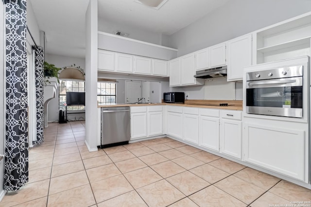 kitchen featuring white cabinetry, sink, light tile patterned floors, and black appliances