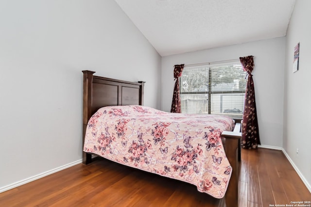 bedroom with dark hardwood / wood-style flooring and lofted ceiling