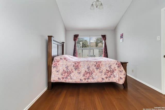 bedroom with hardwood / wood-style flooring and a textured ceiling