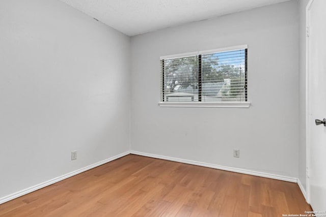 spare room with hardwood / wood-style flooring and a textured ceiling