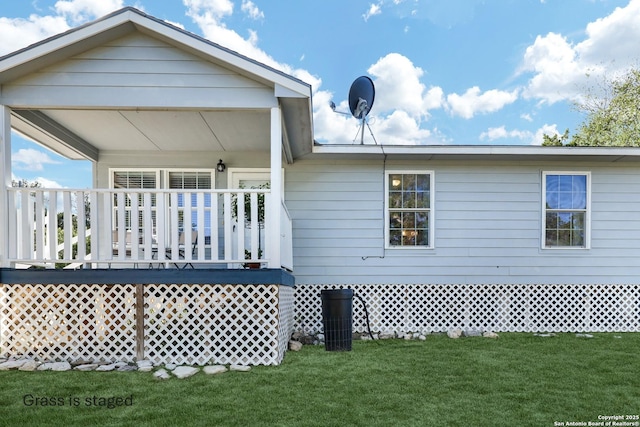 rear view of house featuring a yard