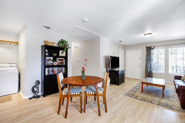 dining space featuring washer / clothes dryer and light wood-type flooring