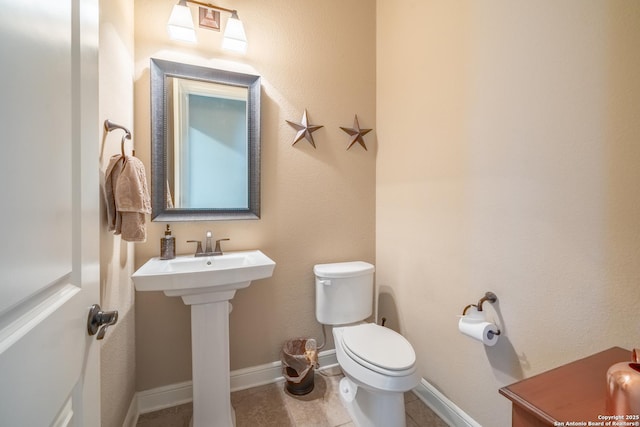 bathroom with tile patterned floors and toilet