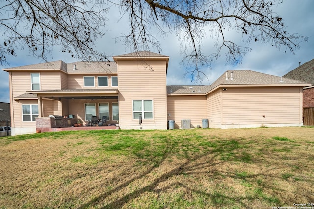 rear view of house featuring a yard, central AC, and a patio