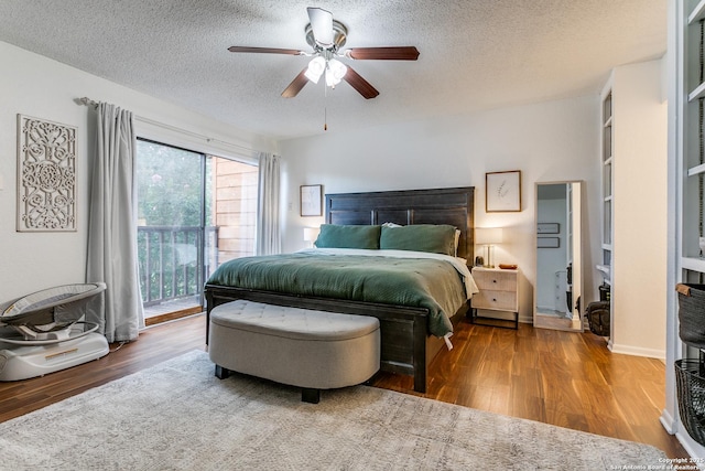 bedroom featuring wood-type flooring, ceiling fan, access to exterior, and a textured ceiling