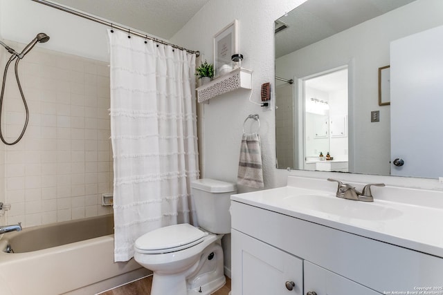 full bathroom with shower / bathtub combination with curtain, vanity, toilet, and a textured ceiling