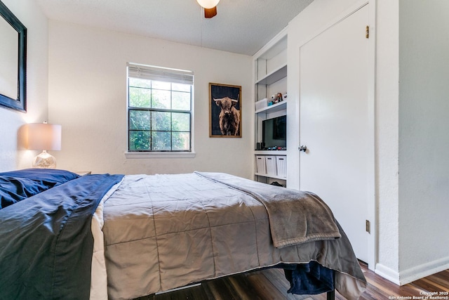 bedroom with dark wood-type flooring and ceiling fan