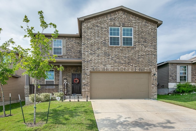 view of front property featuring a garage, a front yard, and a porch