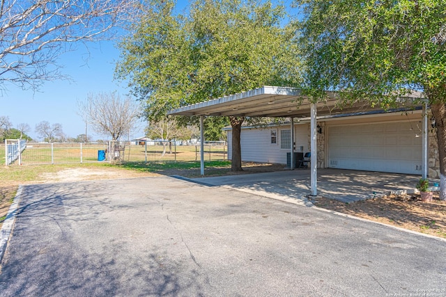 exterior space with a carport and a garage