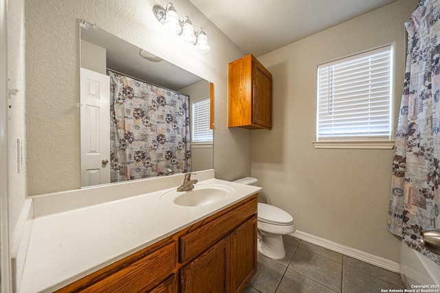 bathroom with tile patterned flooring, vanity, and toilet