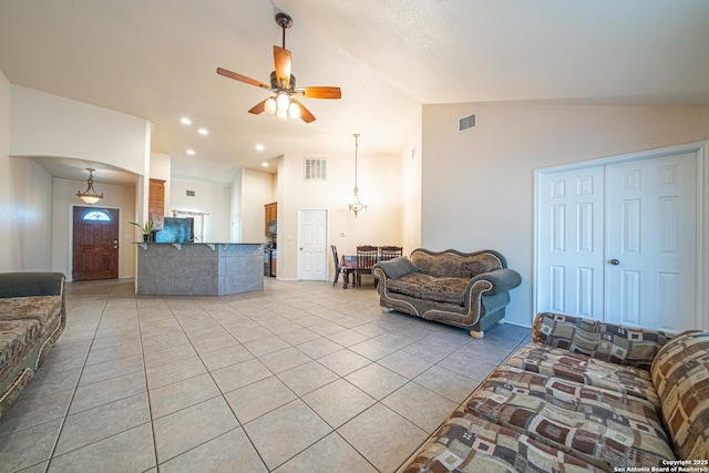 tiled living room with lofted ceiling and ceiling fan