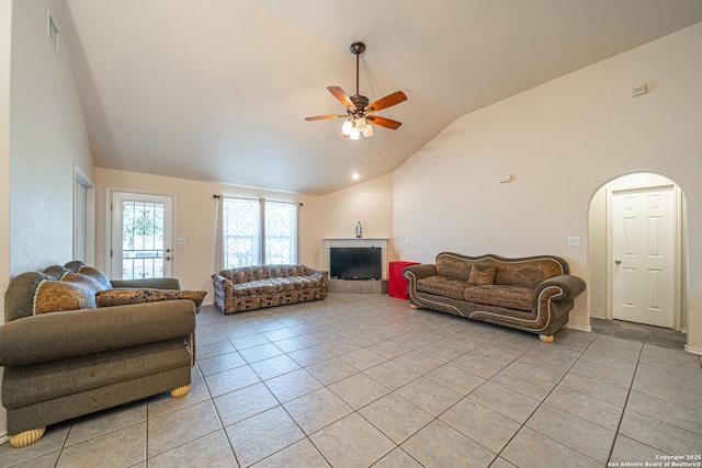 living room featuring ceiling fan, high vaulted ceiling, and light tile patterned floors